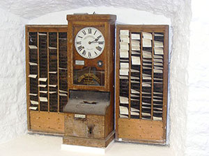 Very old time clock with shelves.